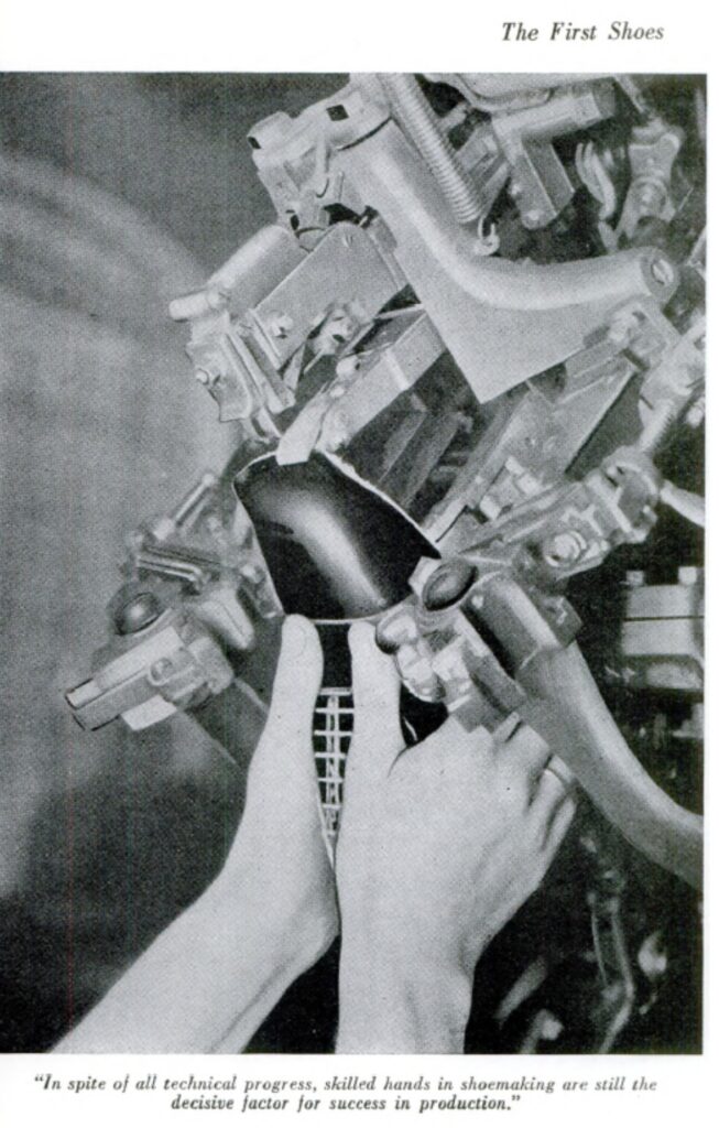 Two hands of one individual holding a shoe to place it in a complex-looking industrial machine for processing. In-image caption reads: "In spite of all technical progress, skilled hands in shoemaking are still the decisive factor for success in production."