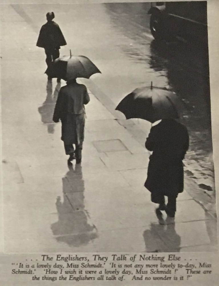 People walking on sidewalk in the rain, two with umbrellas and one with a cloak